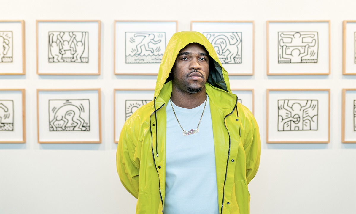 A$AP Ferg poses in front of Keith Haring drawings
