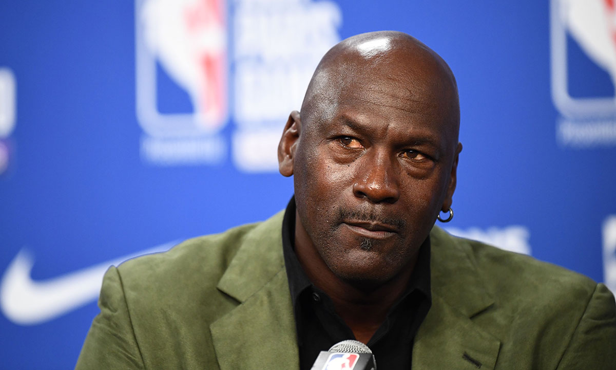 Michael Jordan looks on as he addresses a press conference