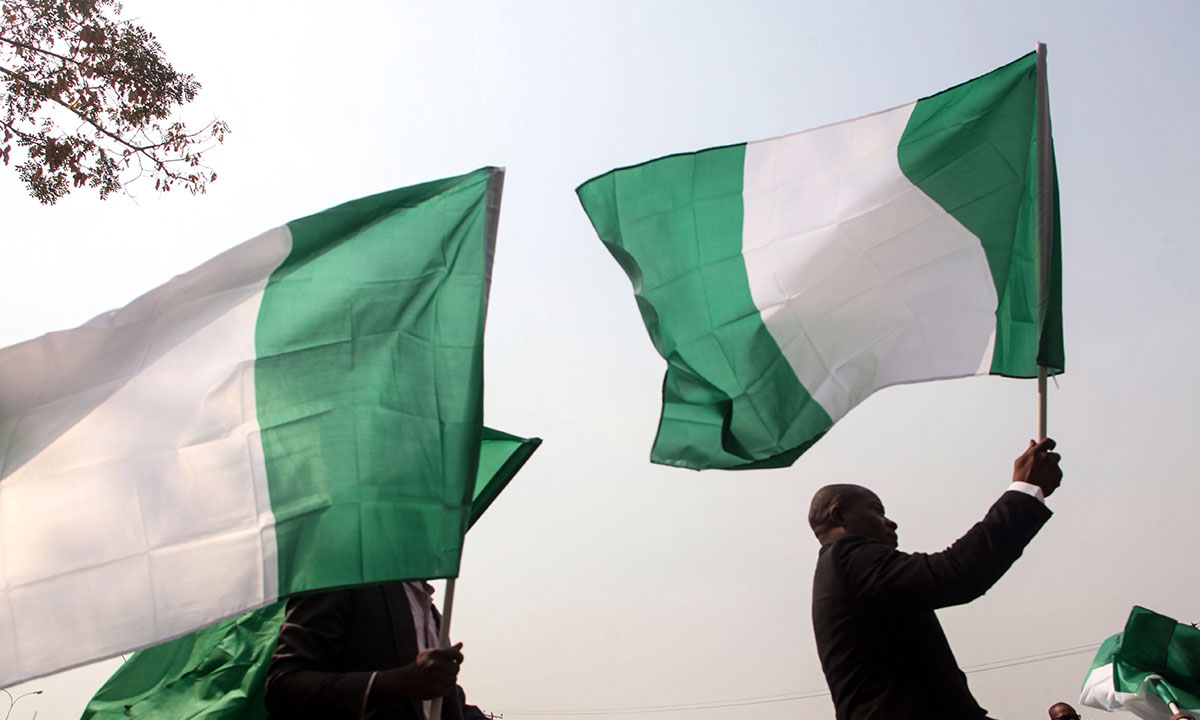 Nigerian lawyers hold up the national flag