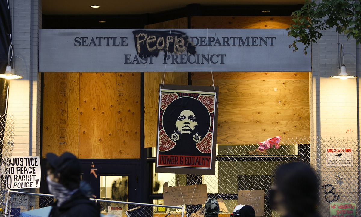 An image of activist Angela Davis is displayed above the entrance to the Seattle Police Department