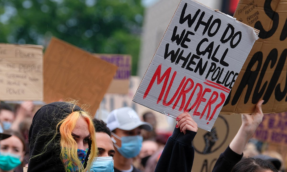 A protestor holds a placard at black lives matter protest