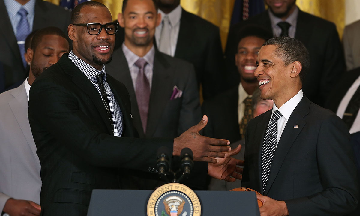 LeBron James (L) speaks to U.S. President Barack Obama (R) during an event to honor the NBA champion Miami Heat