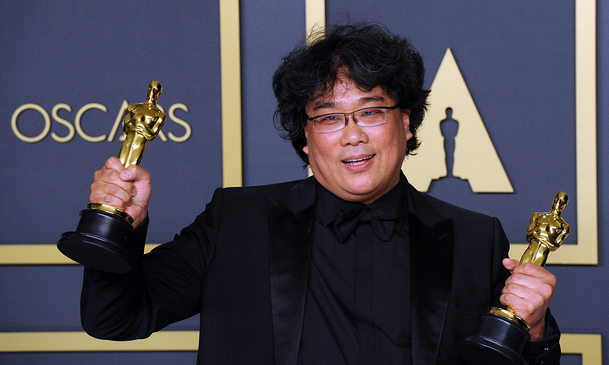Bong Joon Ho poses with his Awards for Best Director and Best Picture