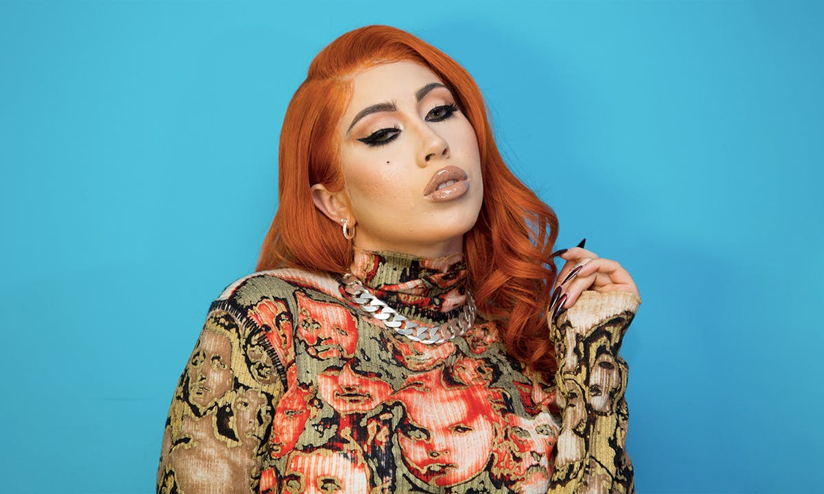 Kali Uchis Orange hair blue background