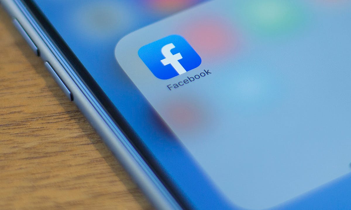 The Facebook logo is seen on a phone