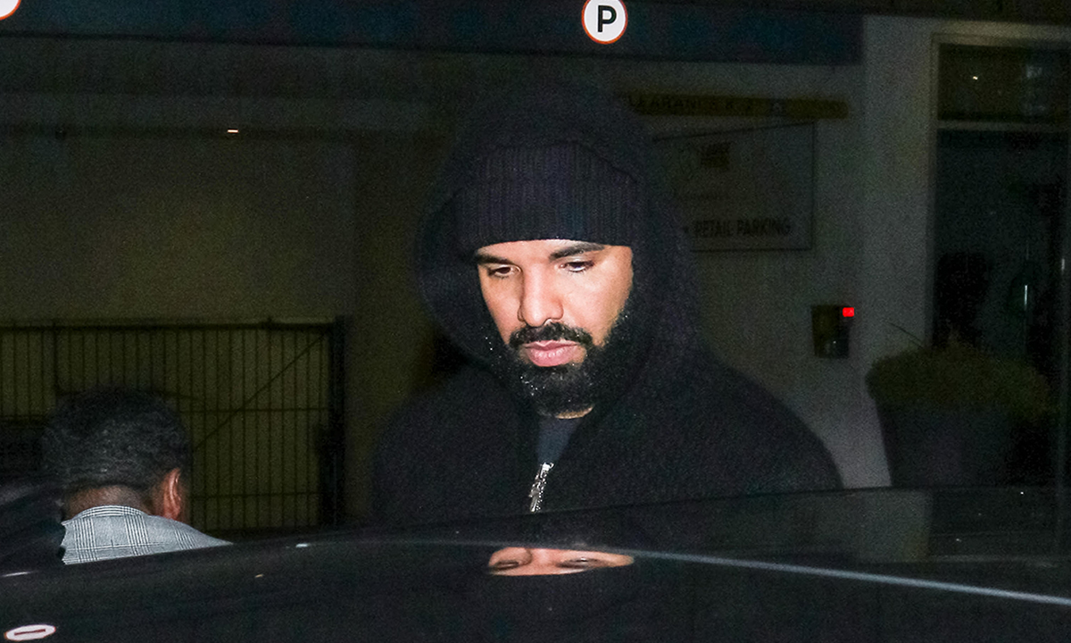 Drake seen stepping into a car with hoodie up