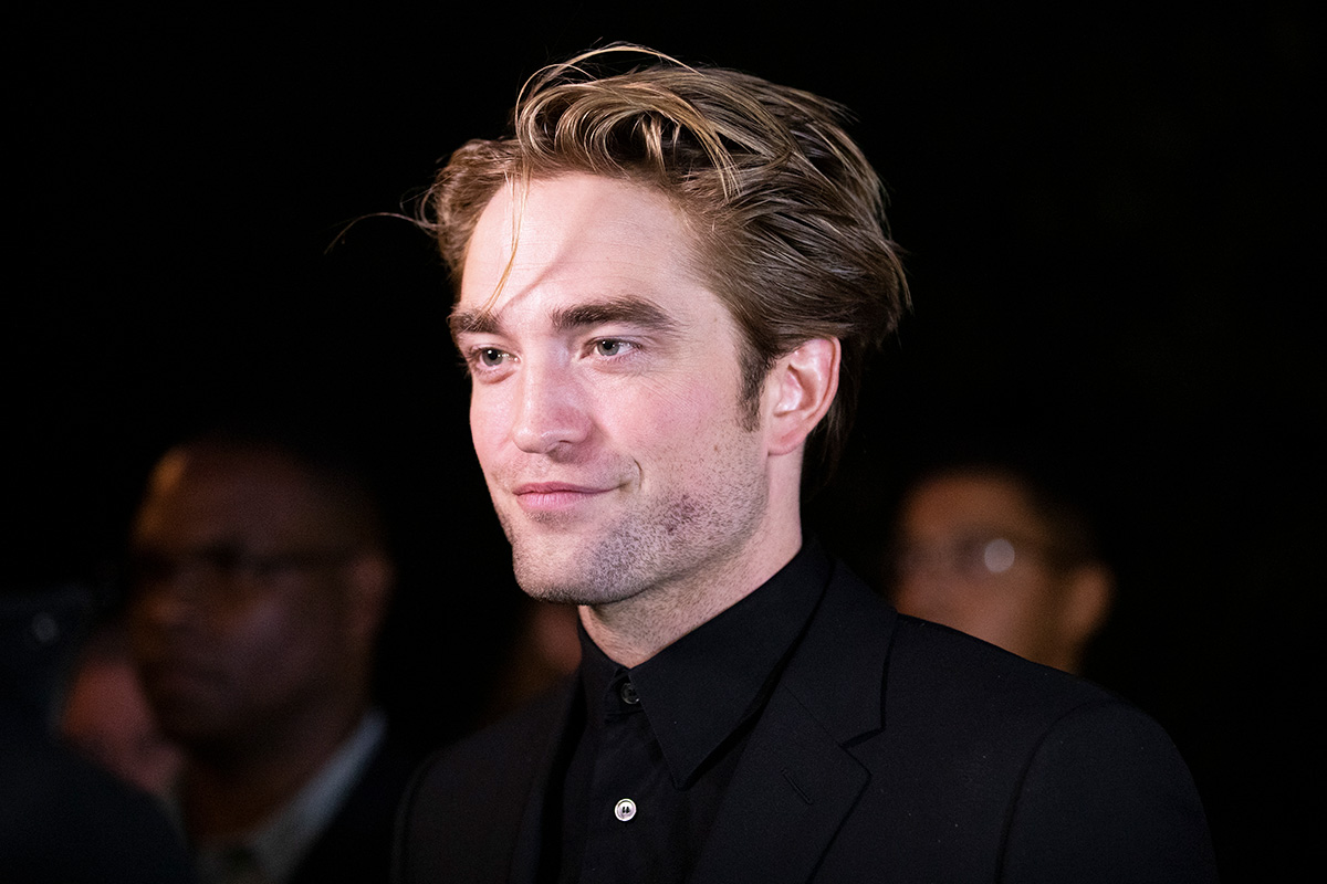 Robert Pattinson on the red carpet, black background