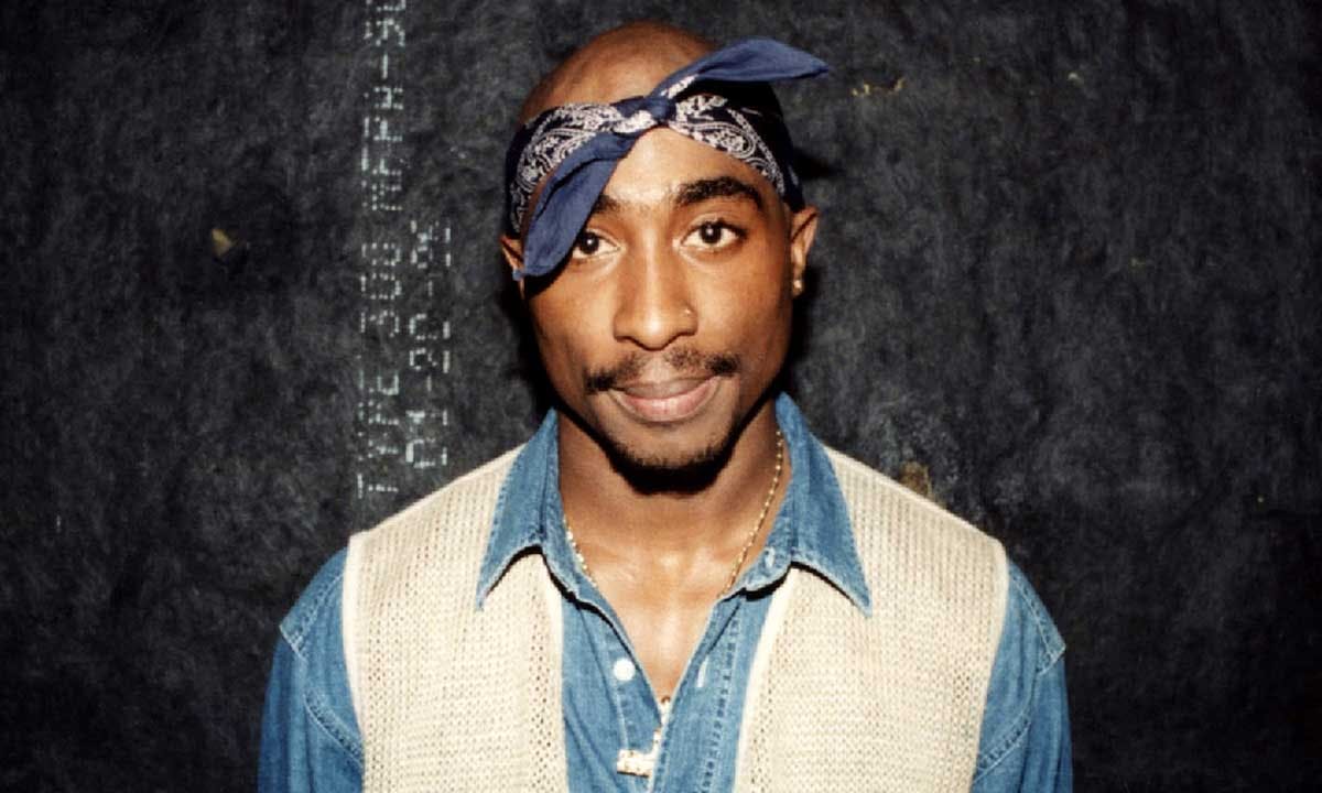 Tupac Shakur poses for photos backstage after his performance