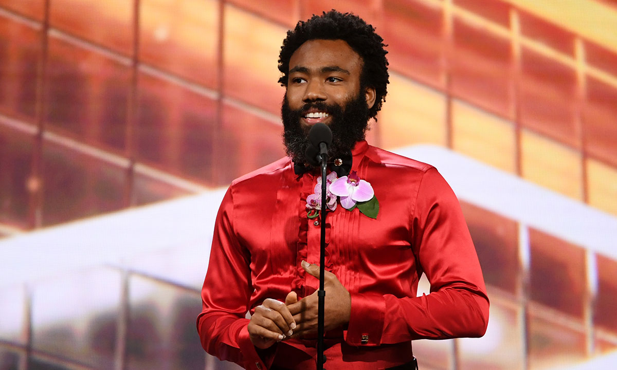Donald Glover on stage in red outfit