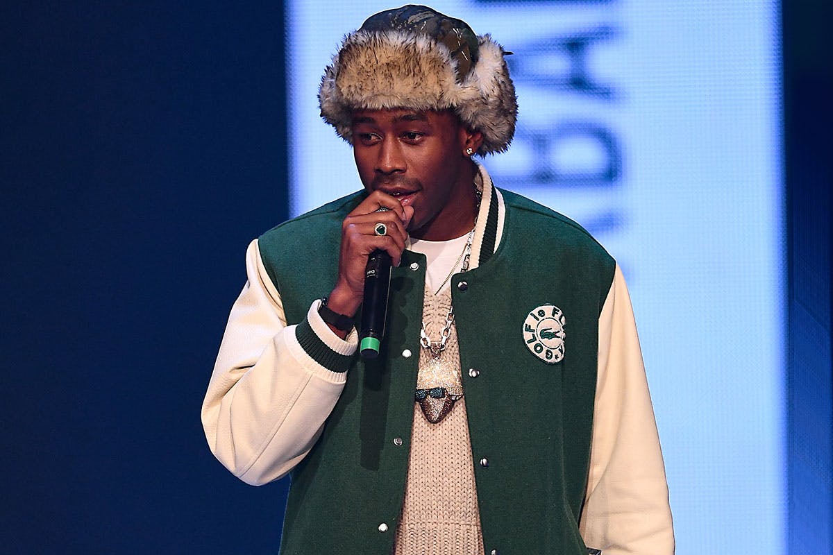 Tyler the creator wearing Golf le Fleur varsity jacket and Igor chain