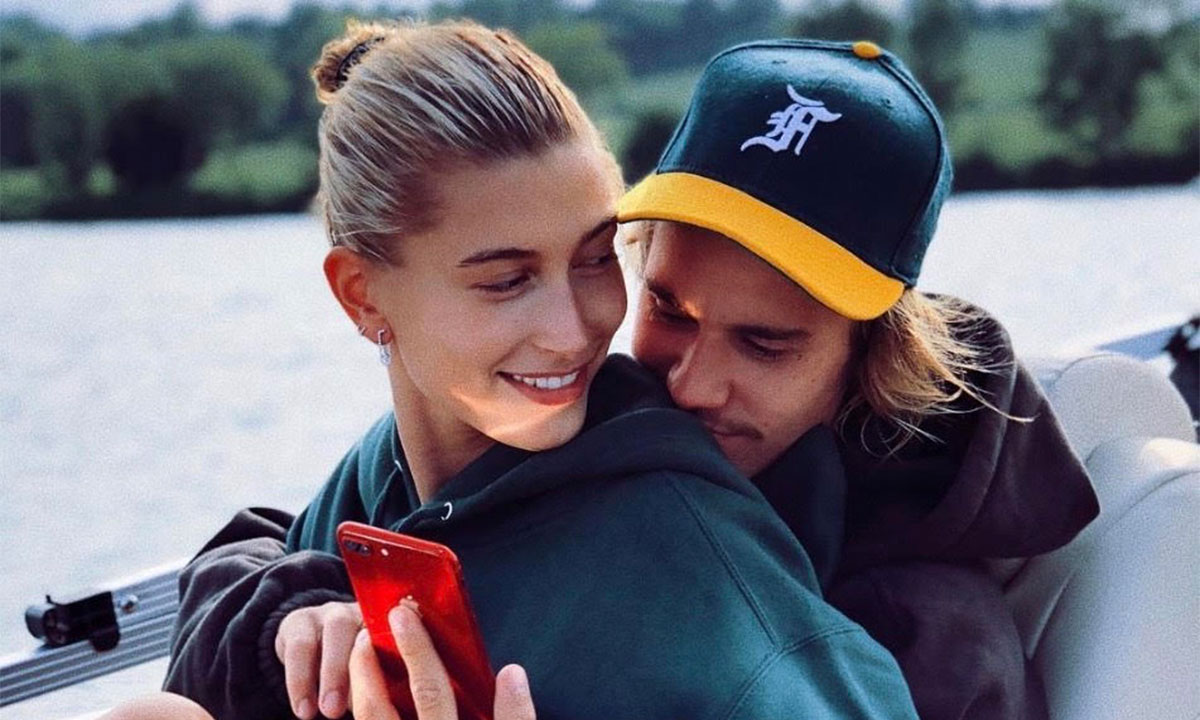 Justin Bieber Hailey Bieber on a boat looking at red phone