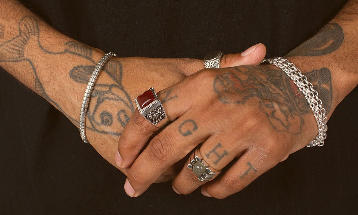 maple solver jewelry on tattoed hands