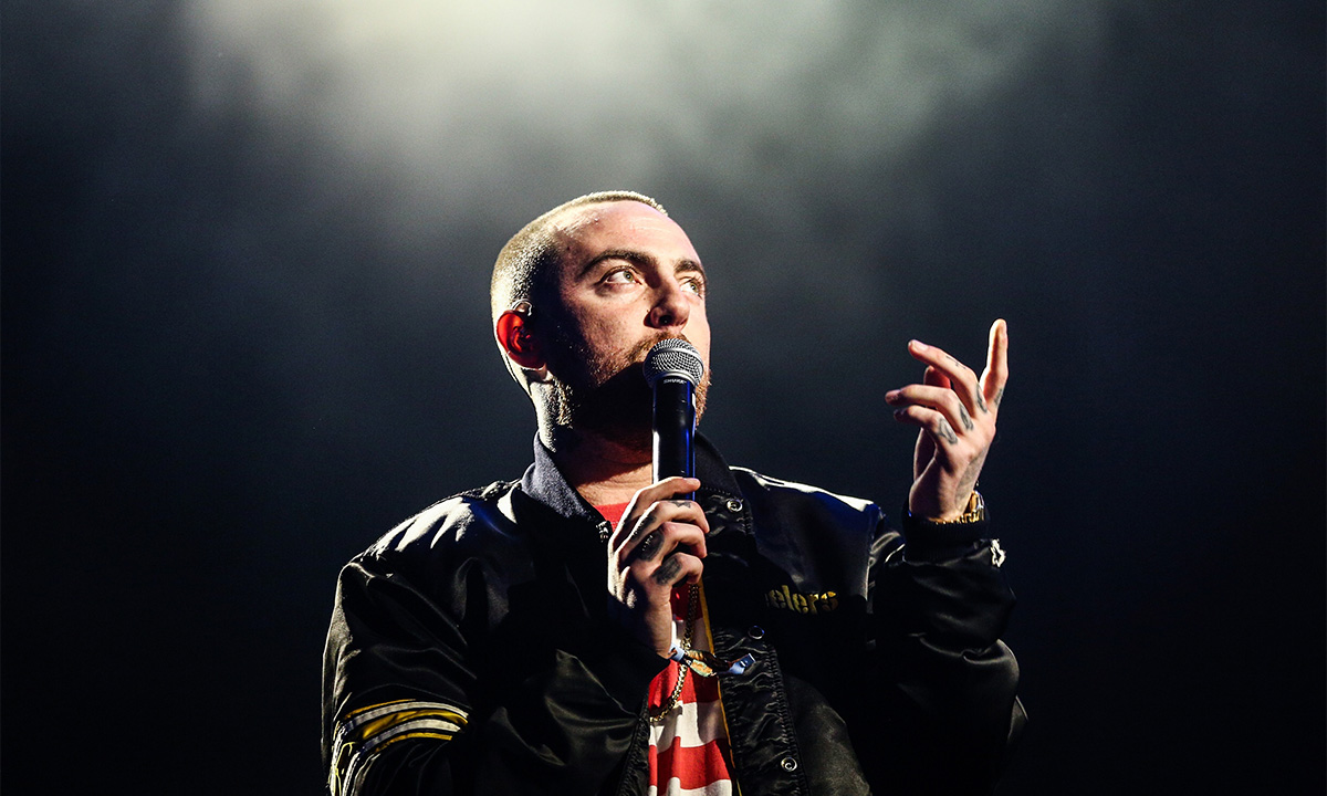 Mac miller performing microphone black jacket