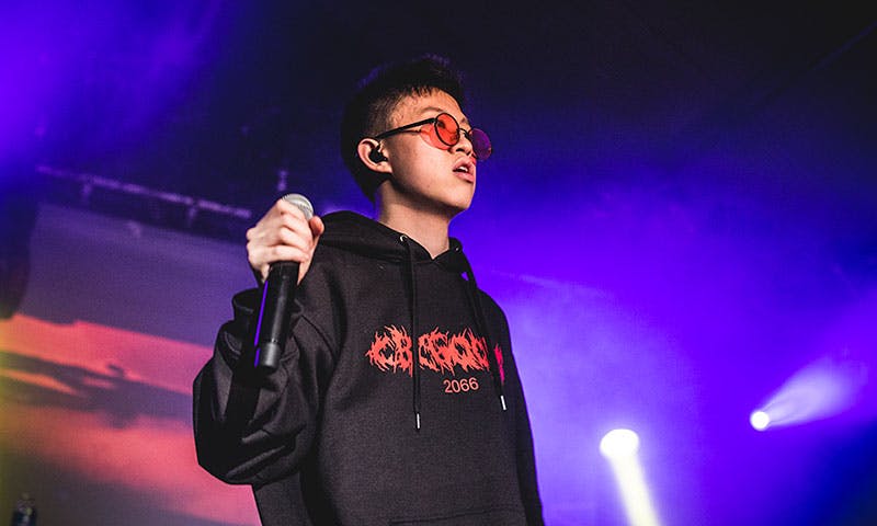 rich Brian performs black hoodie red tinted shades