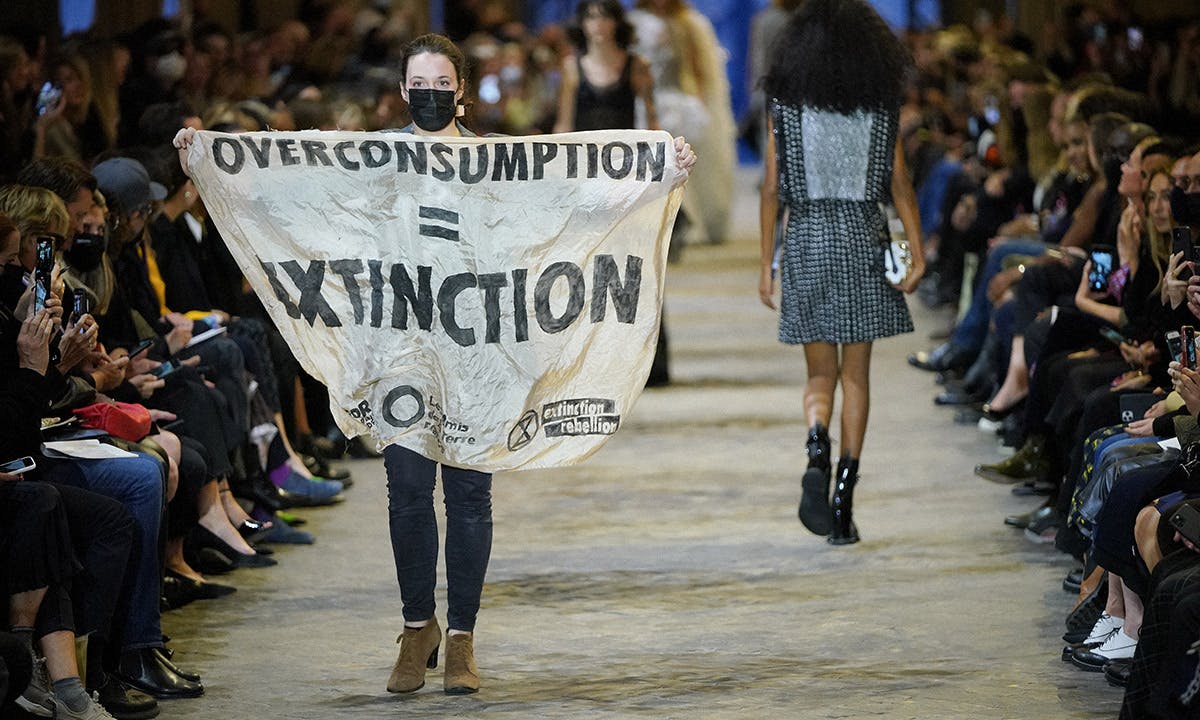 Protestor on Louis Vuitton SS22 Runway Show