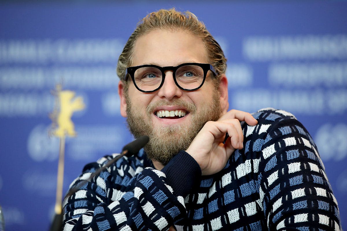 Jonah hill glasses smiling blue background