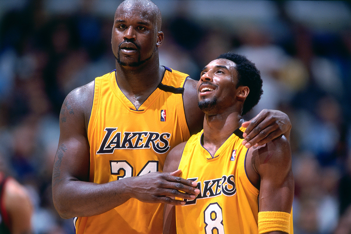Kobe Bryant #8 and Shaquille O'Neal #34 of the Los Angeles Lakers walk and talk during a game
