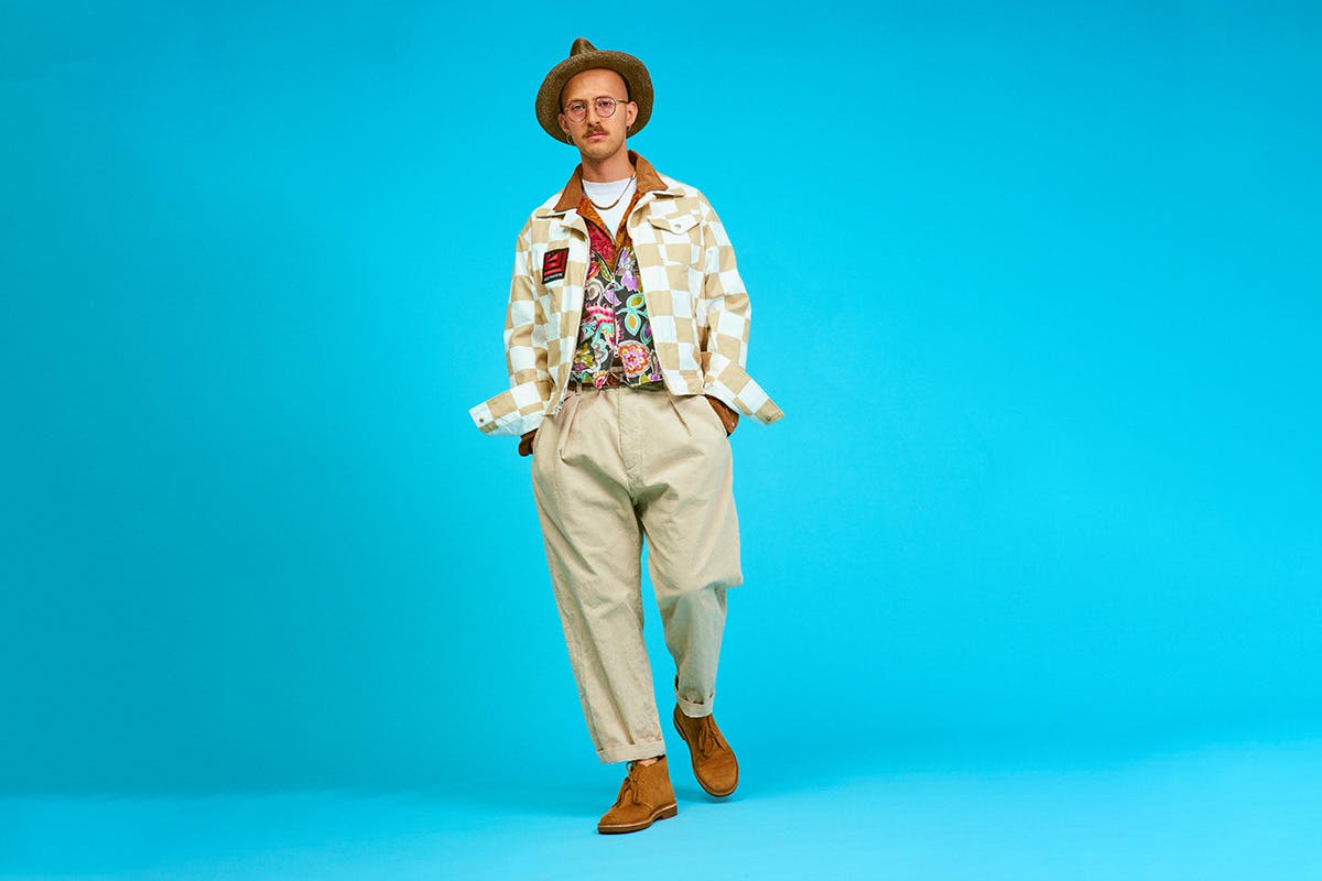 AiE SS20 cream trousers blue background