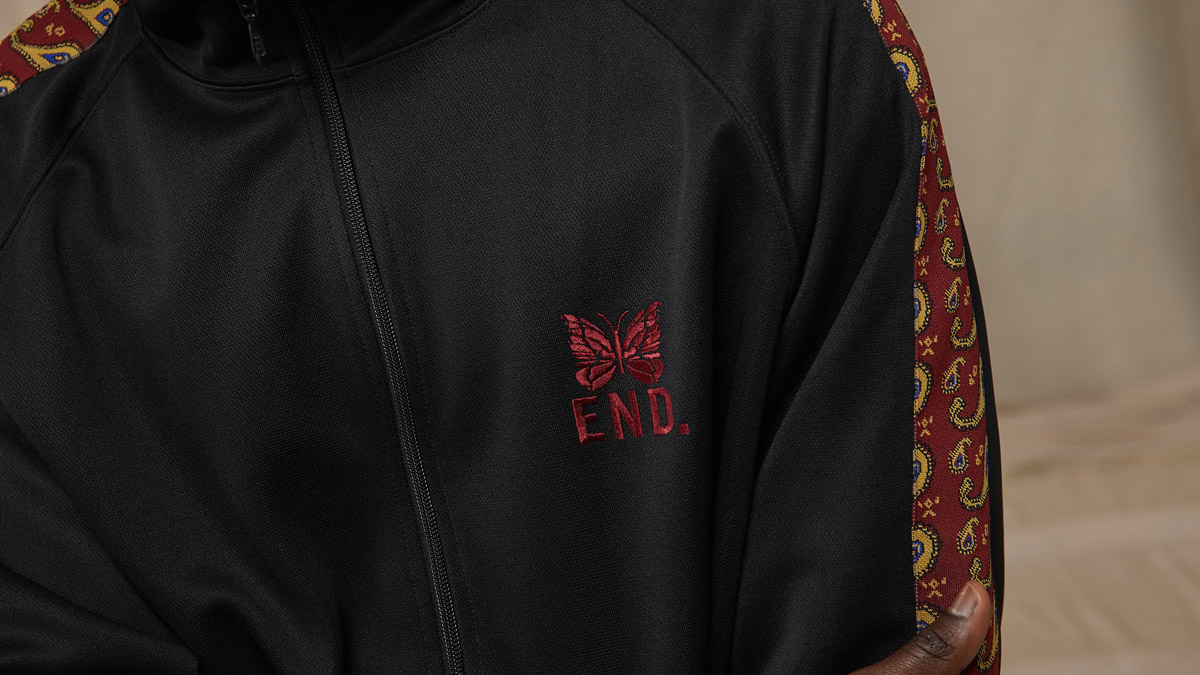 A model wears the END. x Needles track jacket