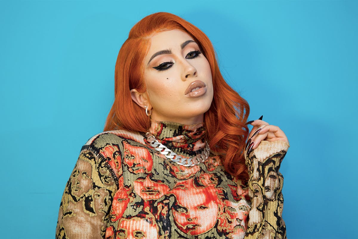 Kali Uchis Orange hair blue background