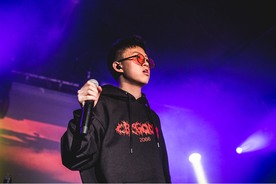 rich Brian performs black hoodie red tinted shades