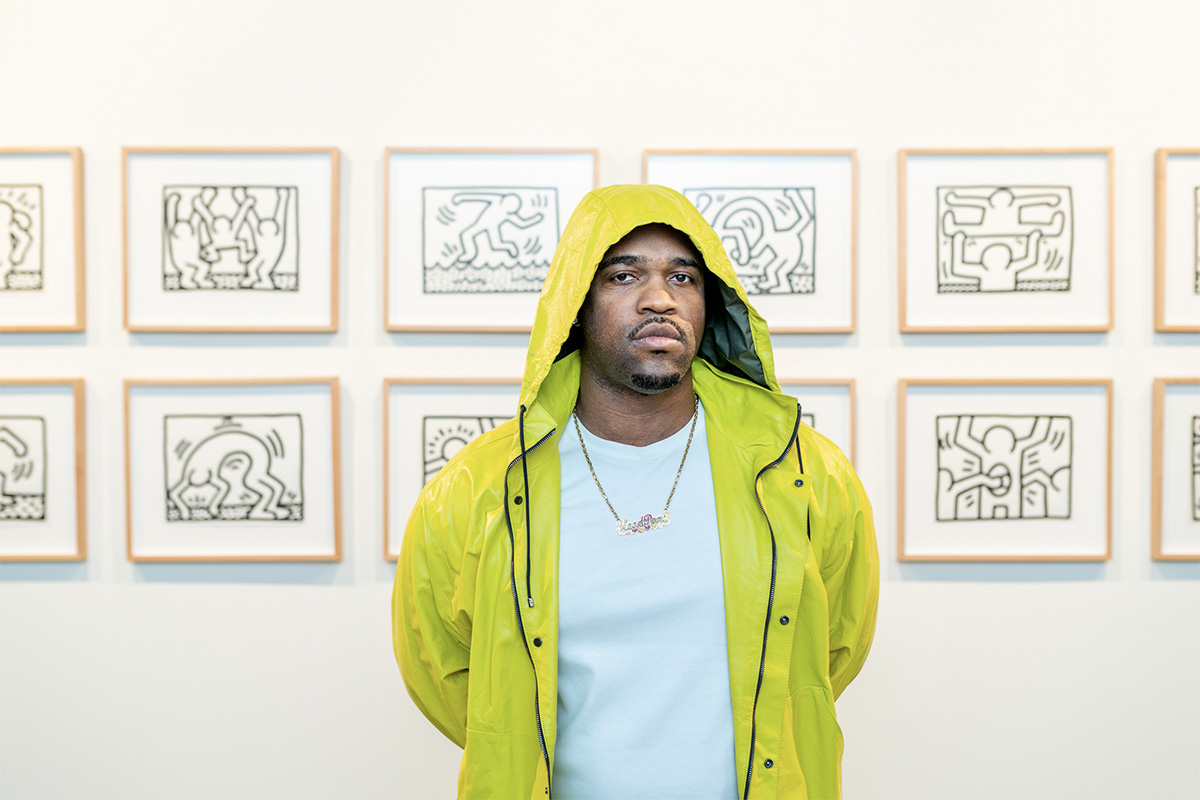 A$AP Ferg poses in front of Keith Haring drawings