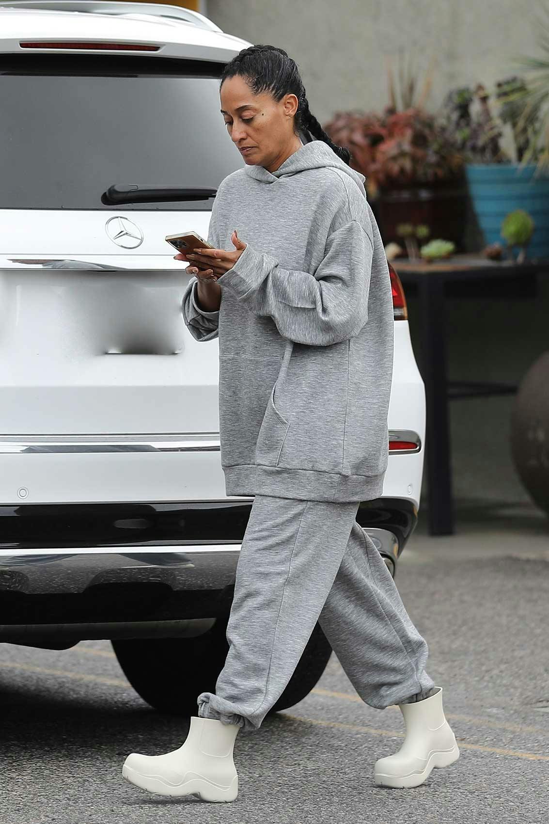 Tracee Ellis Ross wearing a grey sweatsuit and Bottega Veneta boots