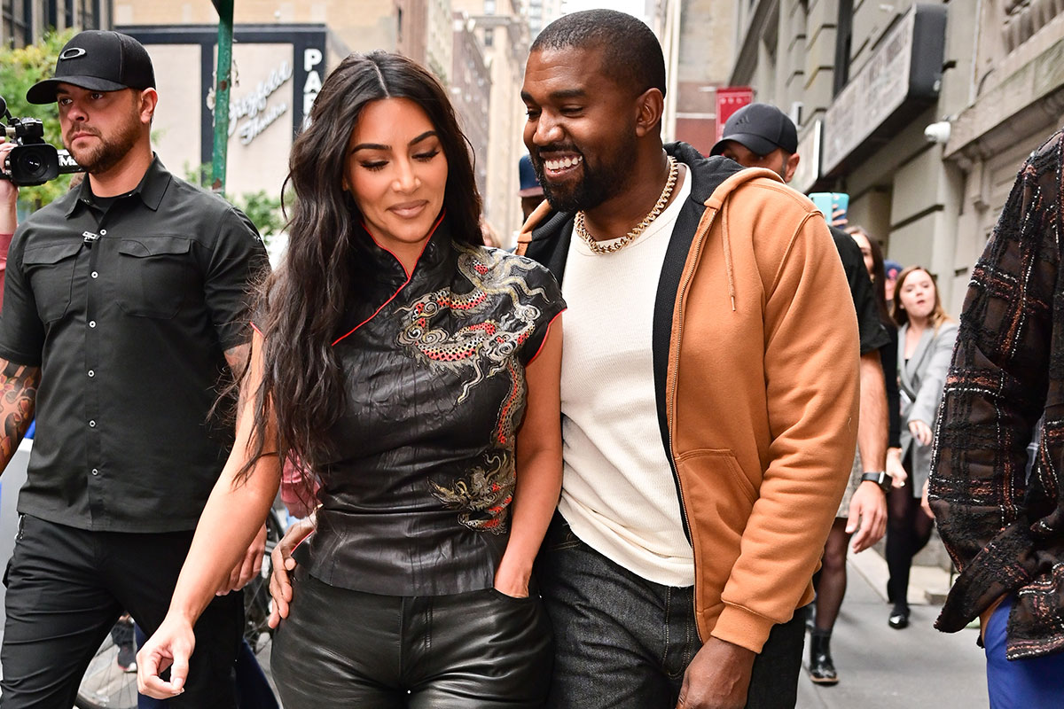 Kim Kardashian and Kanye West smiling walking together