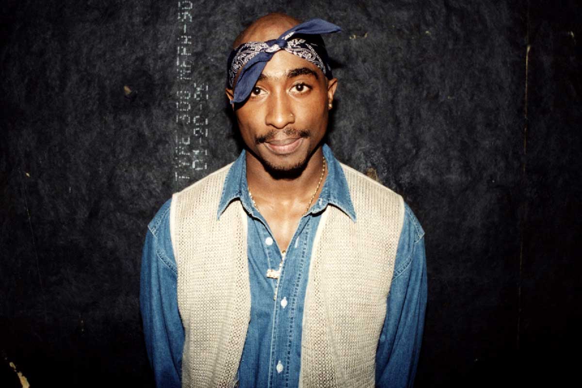 Tupac Shakur poses for photos backstage after his performance