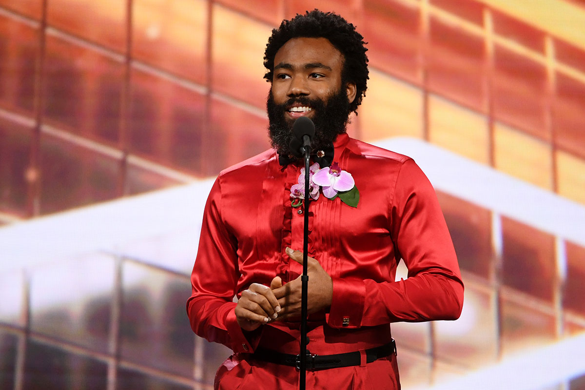 Donald Glover on stage in red outfit