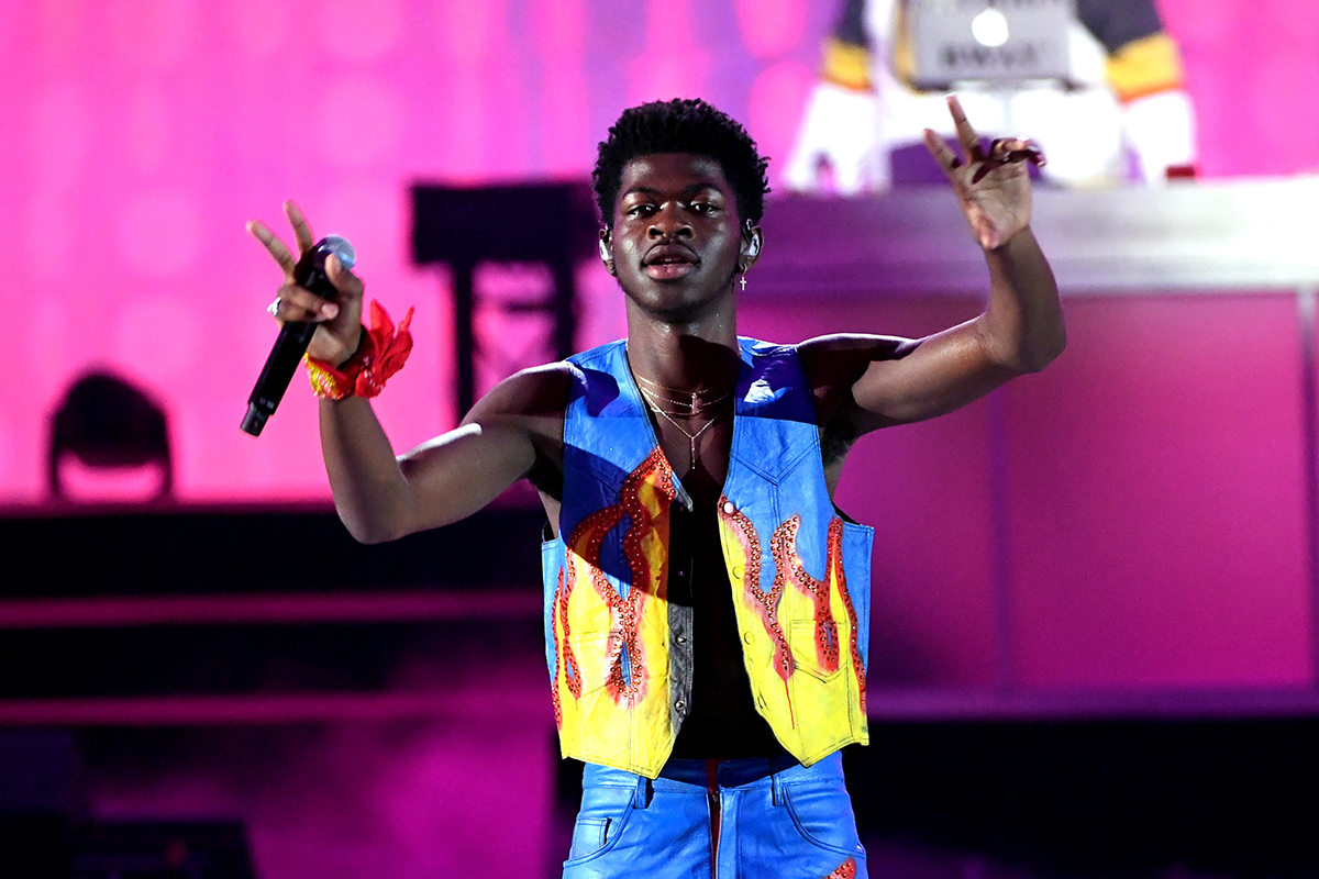 lil nas x performing wearing flame vest