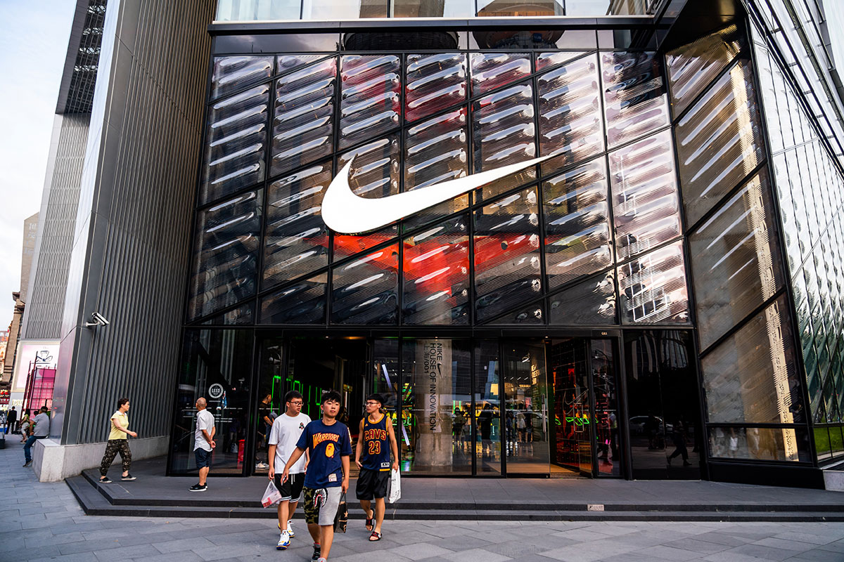 buyers leaving nike store with swoosh logo