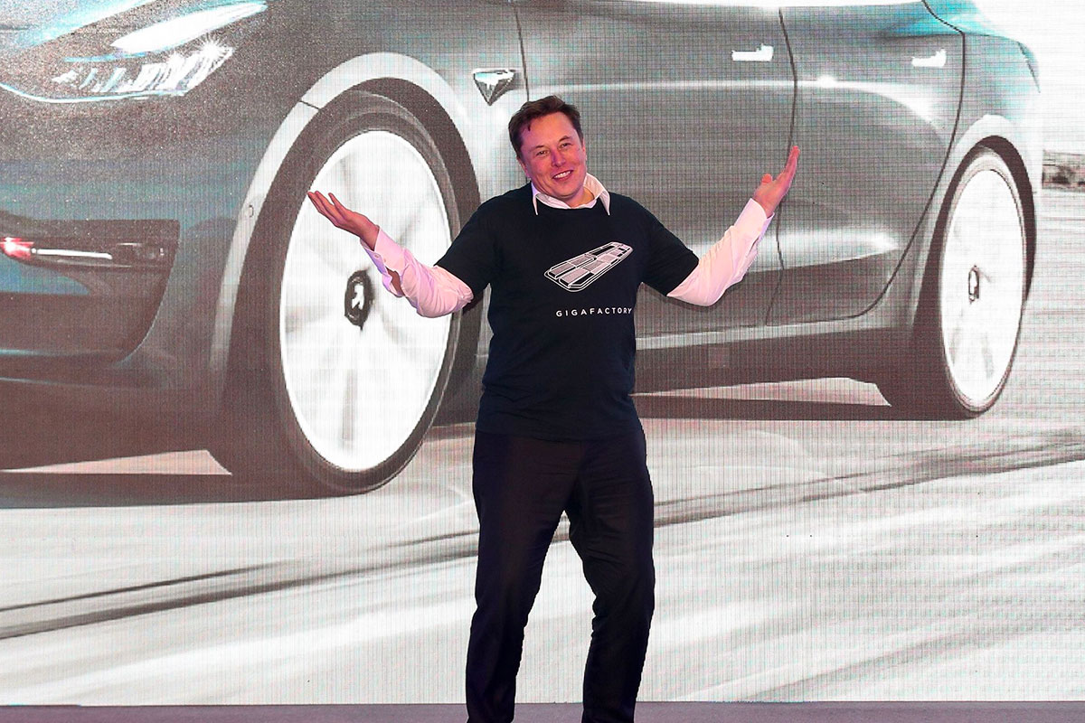 Elon Musk shrugs onstage
