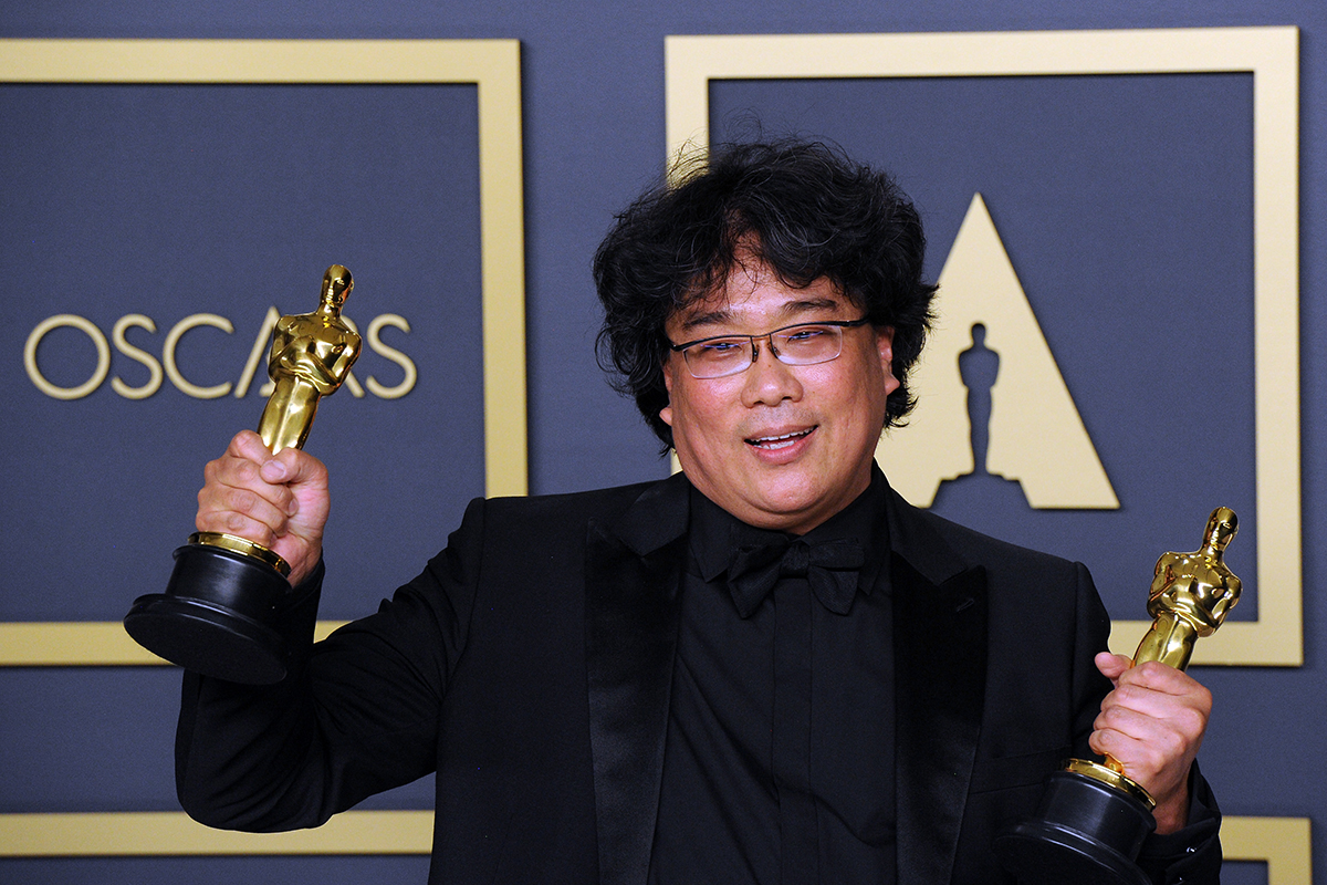 Bong Joon Ho poses with his Awards for Best Director and Best Picture