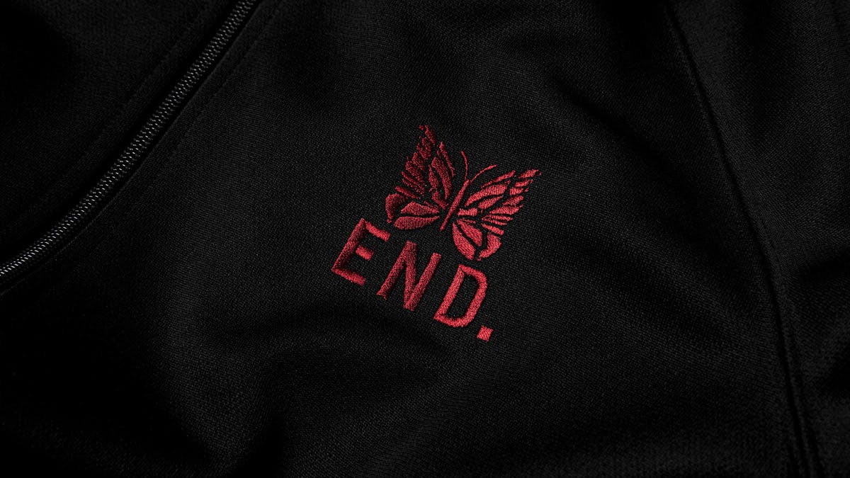 A model wears the END. x Needles track jacket