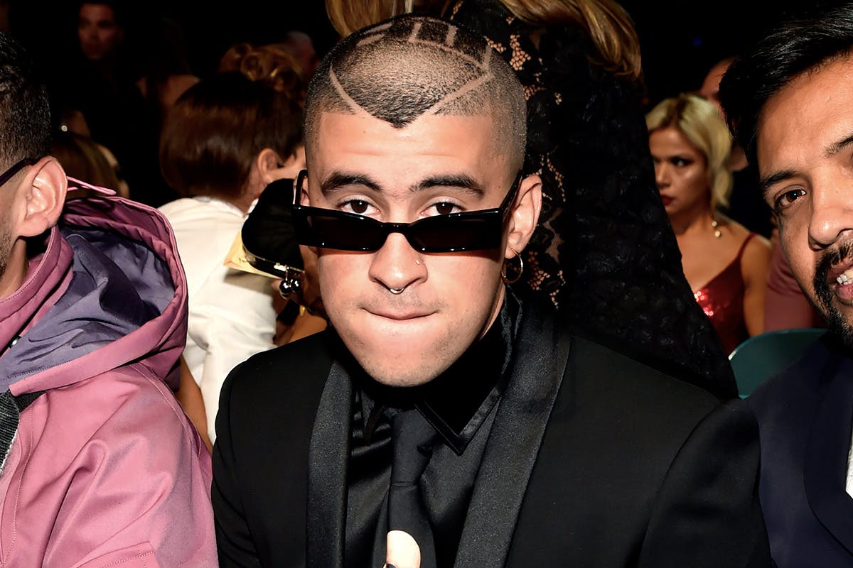 Bad Bunny black suit seated front row