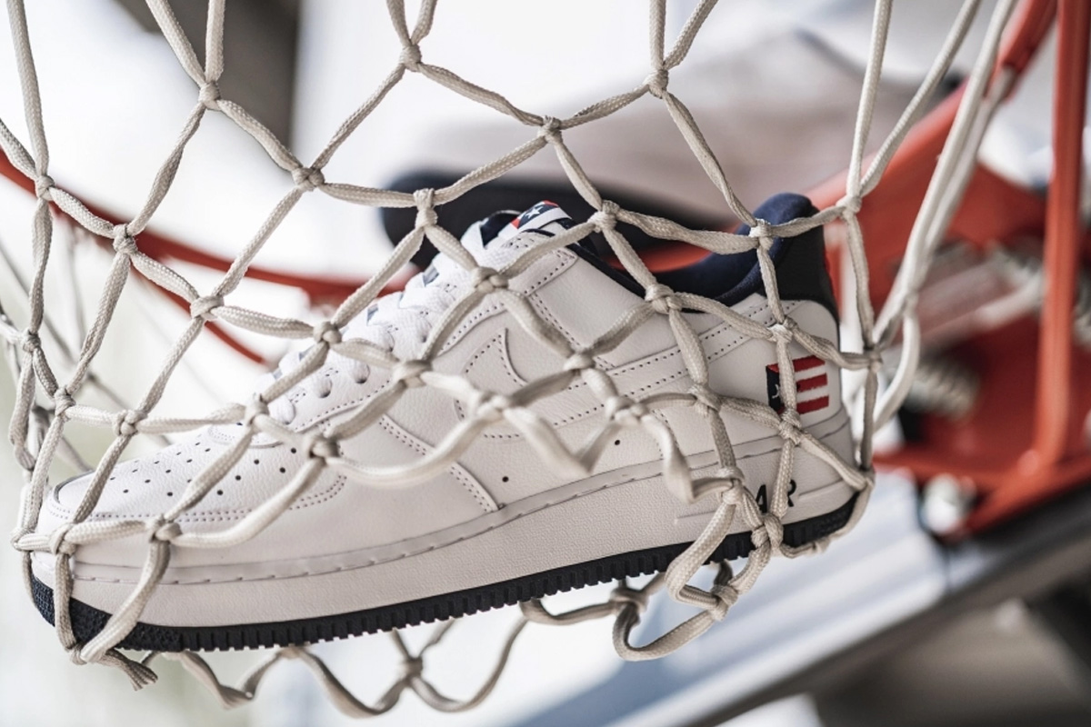 white leather Puerto Rico Nike Air Force 1 hanging in a basketball net