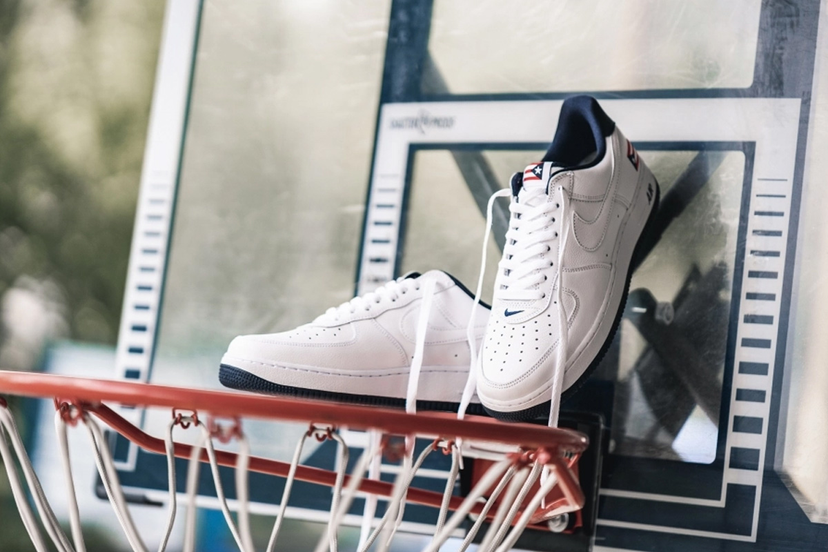 white leather Puerto Rico Nike Air Force 1 hanging in a basketball net