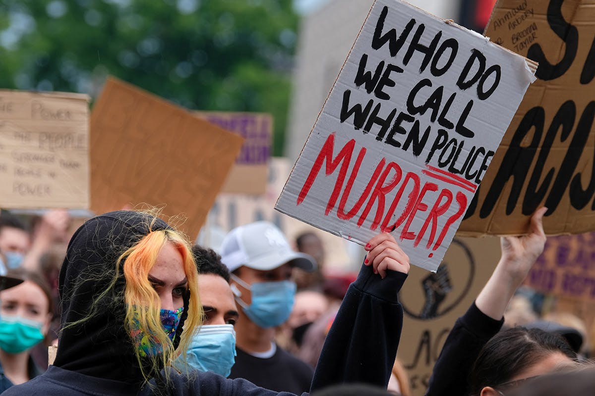 A protestor holds a placard at black lives matter protest