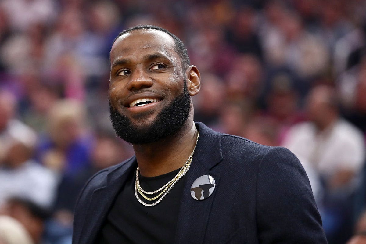 LeBron James #23 of the Los Angeles Lakers sits on the bench injured during their game against the Golden State Warriors at Chase Center on February 27