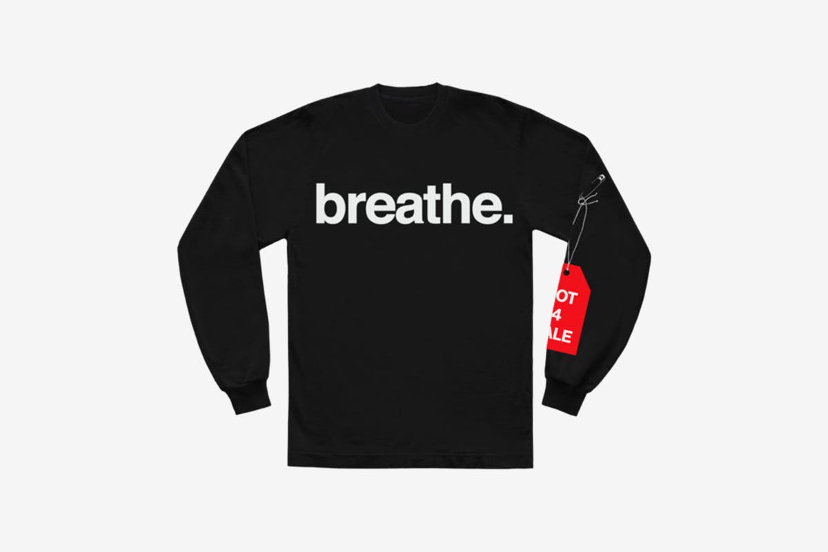 image of Andre' 3000's new sweater with slogan from tour jumpsuits