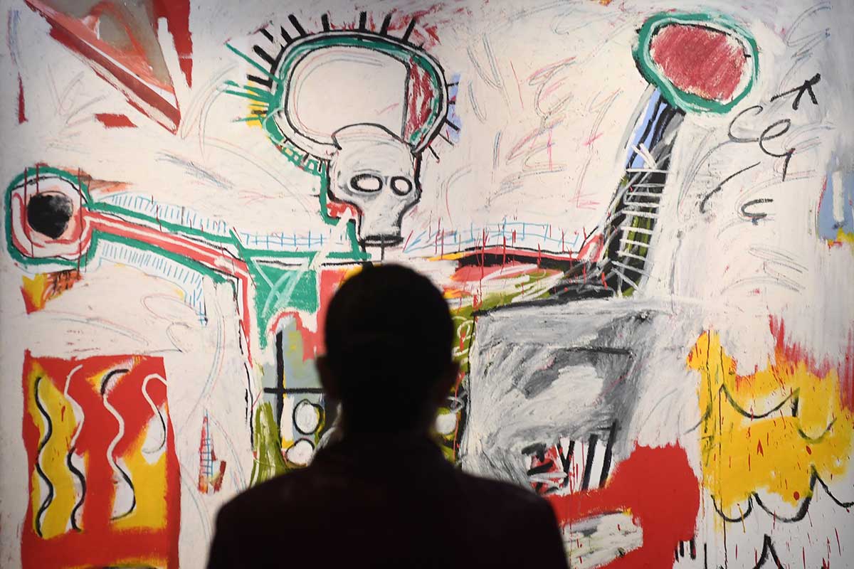 Person looking at Basquiat painting
