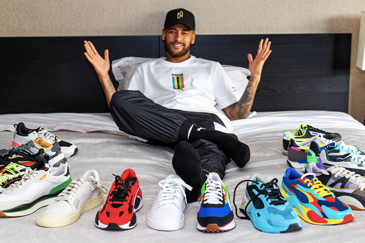 Neymar on a bed with Puma sneakers