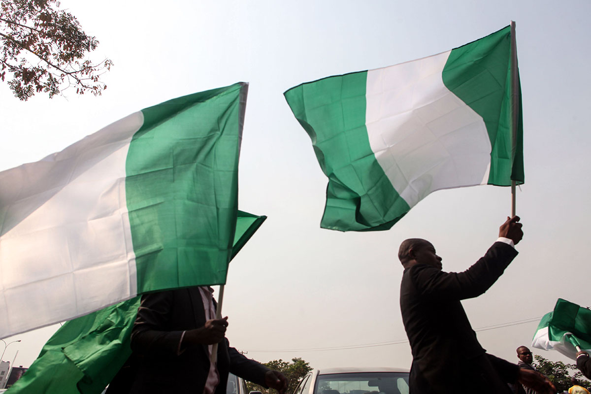 Nigerian lawyers hold up the national flag