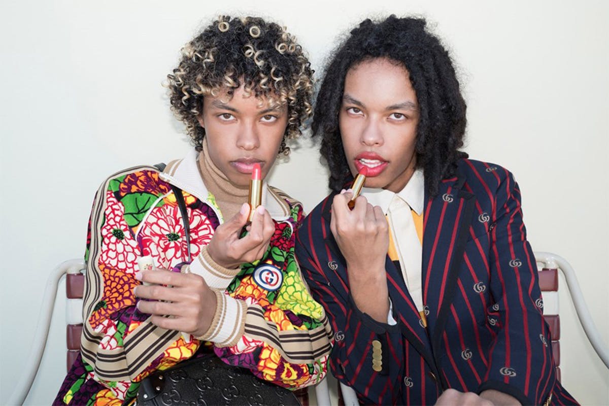 two people posing with lipstick