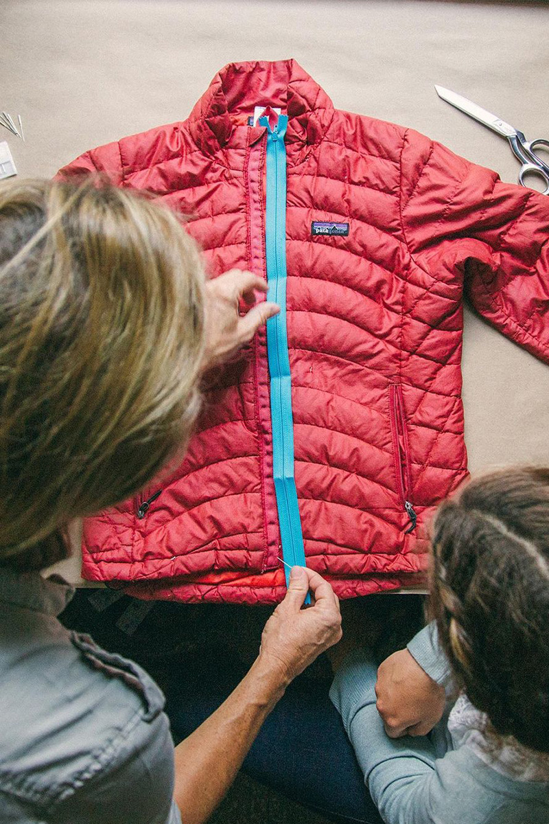 woman and child looking at red patagonia puffer jacket