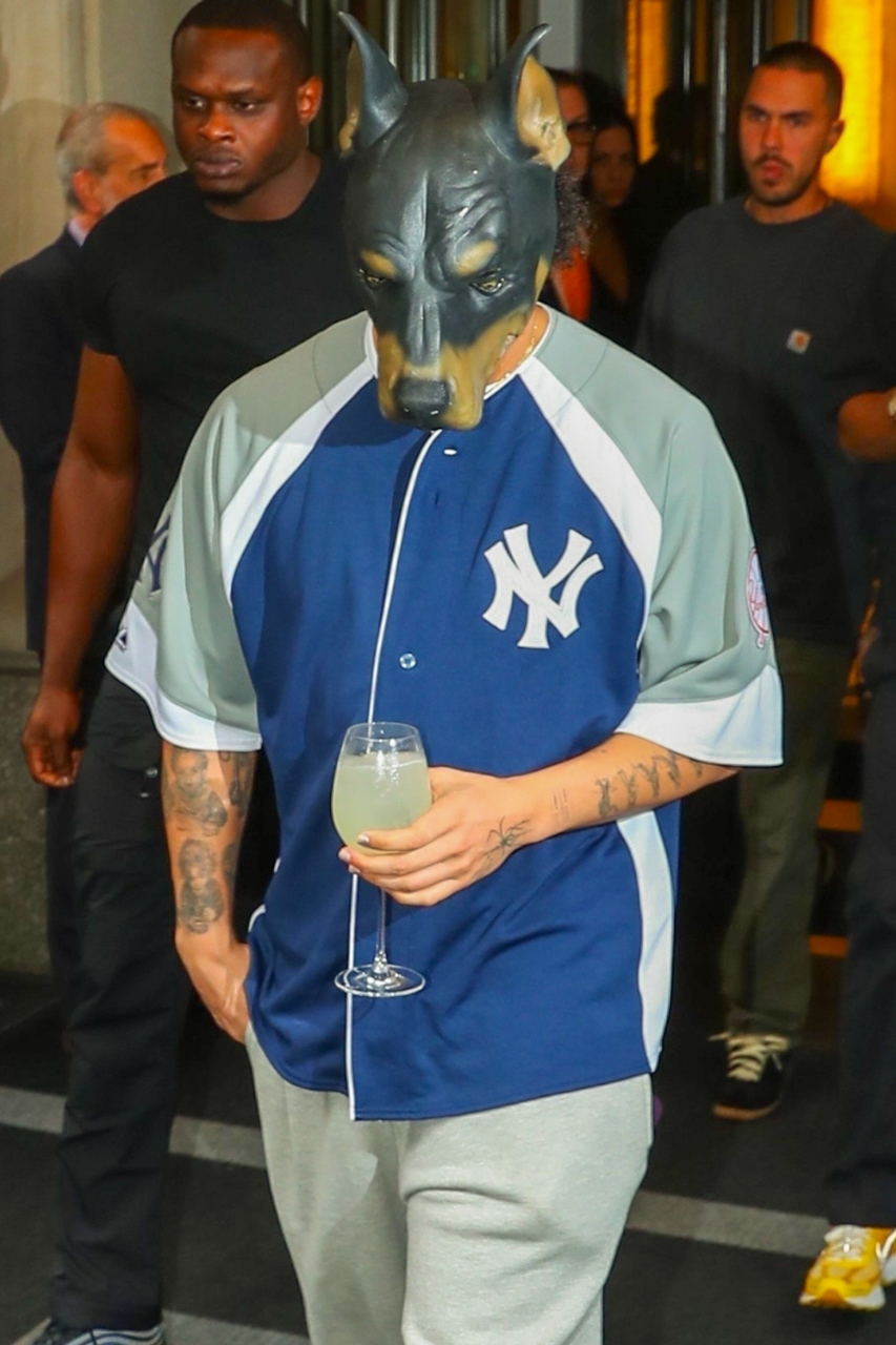 Drake wears a rottweiler-shaped dog mask and New York Yankees jersey with sweatpants