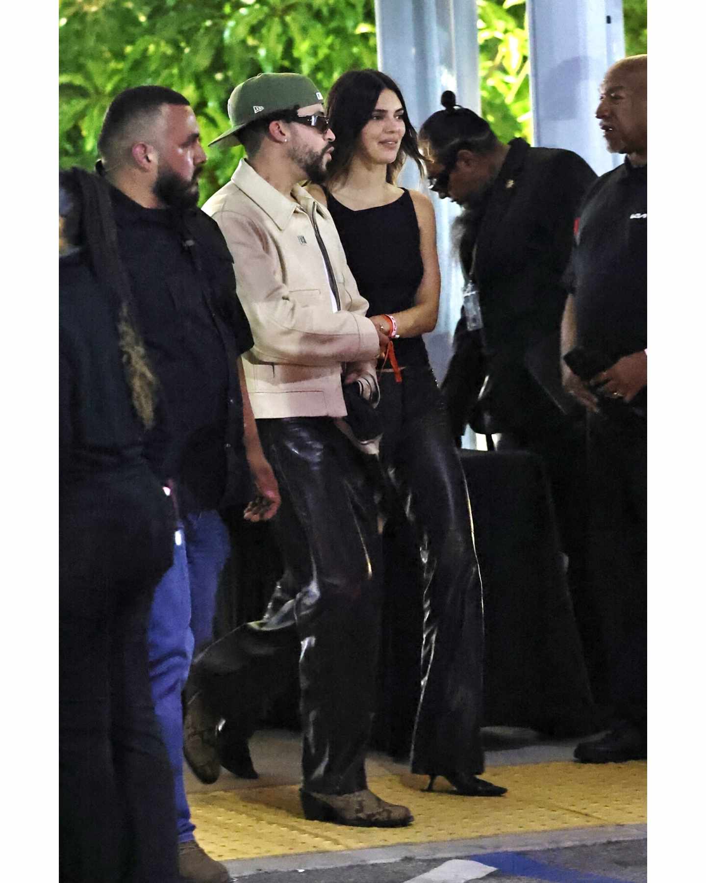 Kendall Jenner & Bad Bunny walk to a Drake concert wearing matching black leather pants