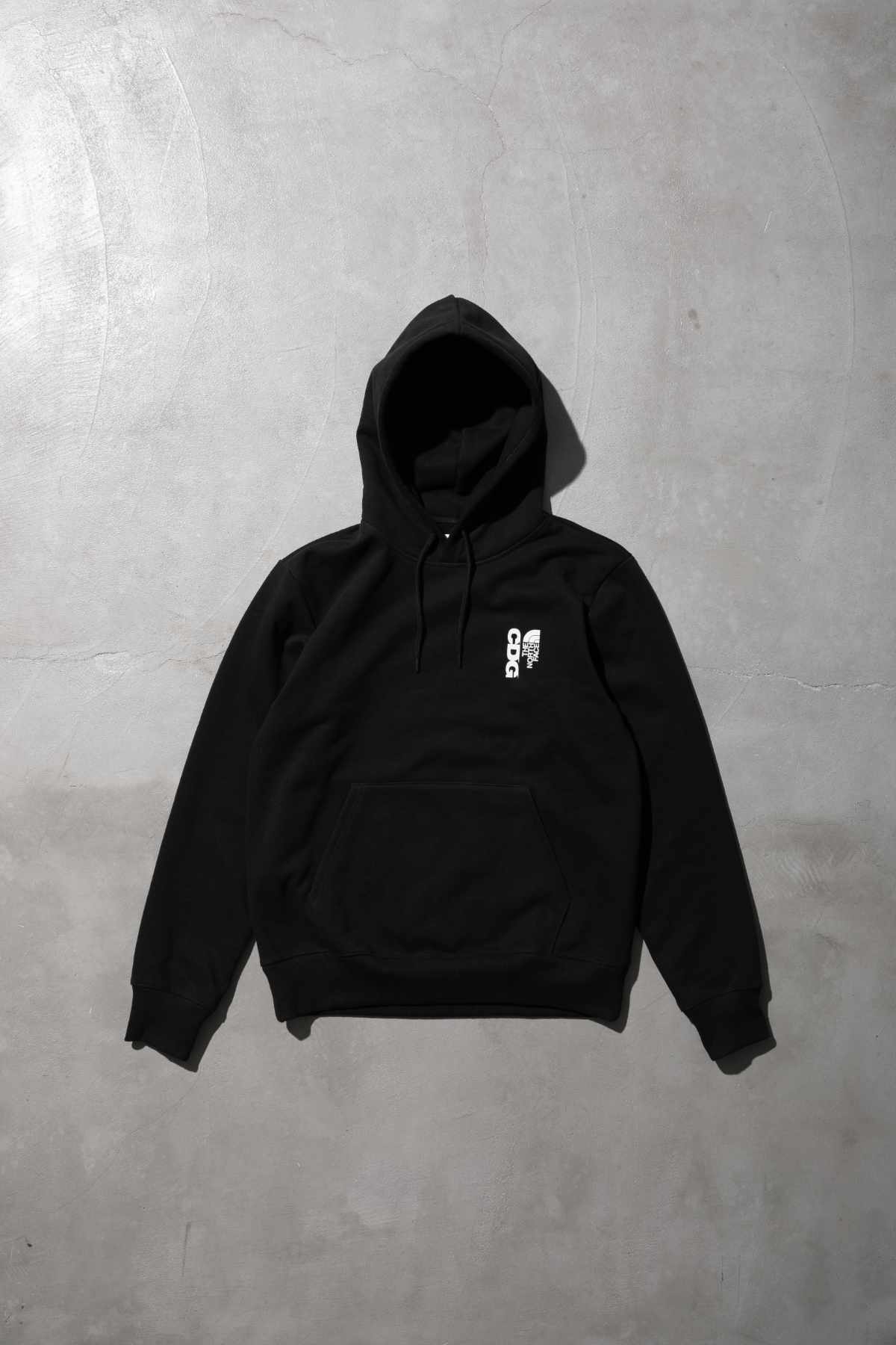 The CDG x TNF collab's black hoodie