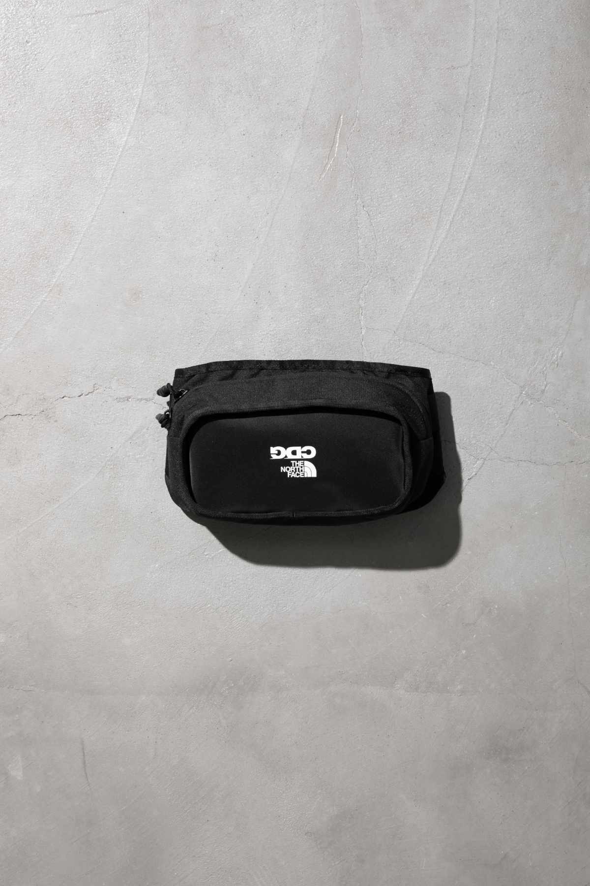 The CDG x TNF collab's black bag
